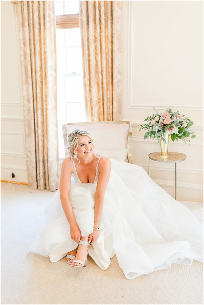 Bride getting into her shoes in the bridal suite 