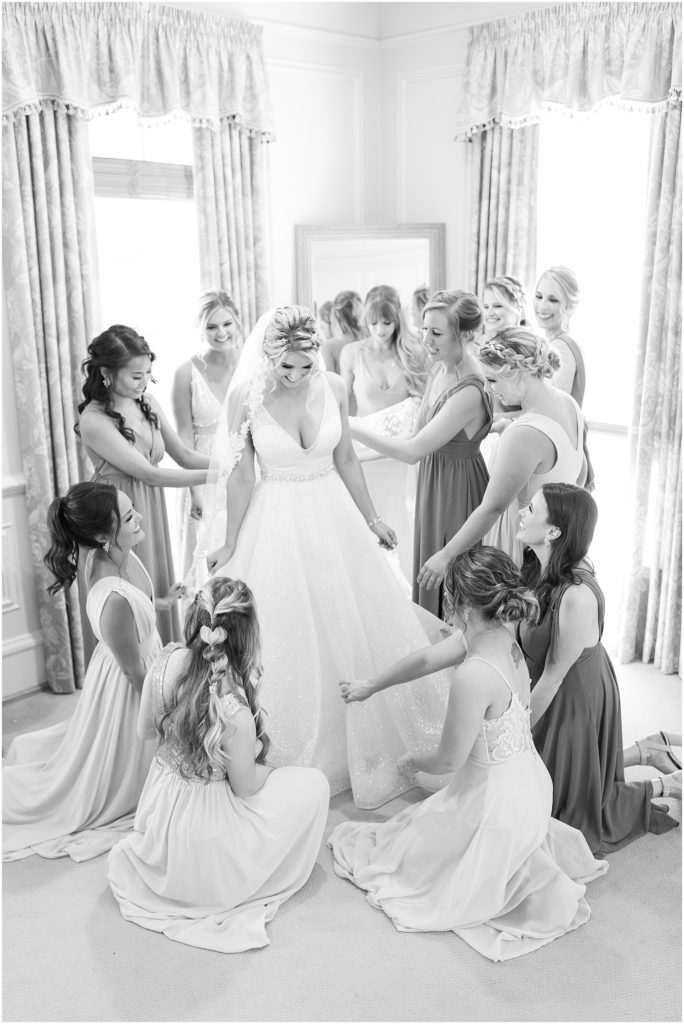 bridesmaids helping bride get ready in Bridal Suite